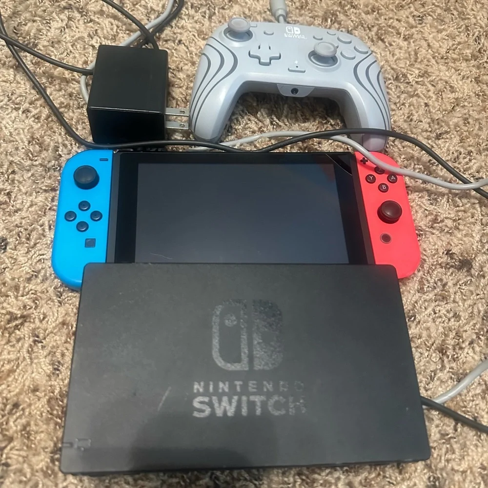 Nintendo Switch Console with Red and Blue Joy-Con and Gray Controller